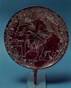 Back of a bronze mirror decorated with a scene showing an old man examining the liver of an animal, bears the name of Chalenas